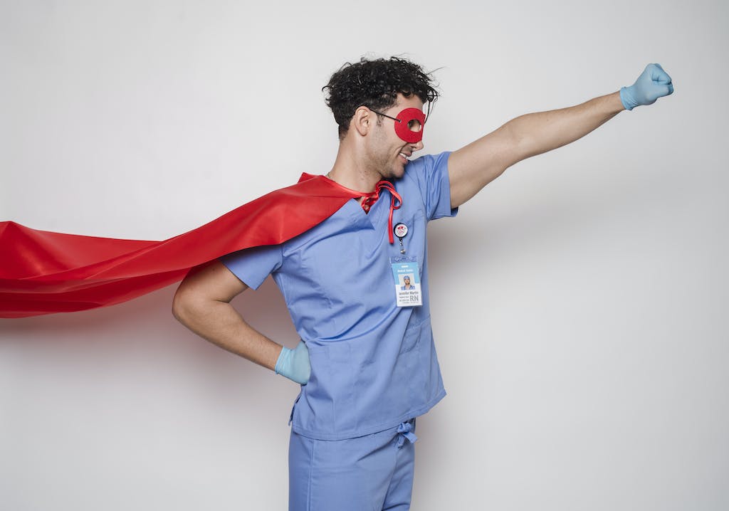 Positive doctor in red superhero costume
